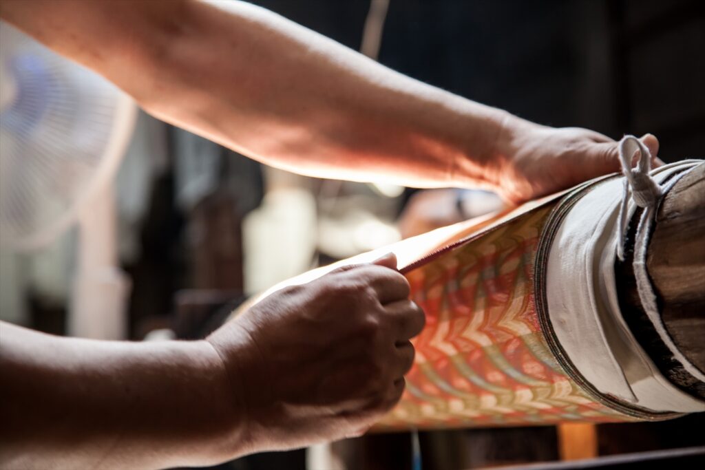 西陣織の最終工程　糊張り加工の職人の手元のアップ写真